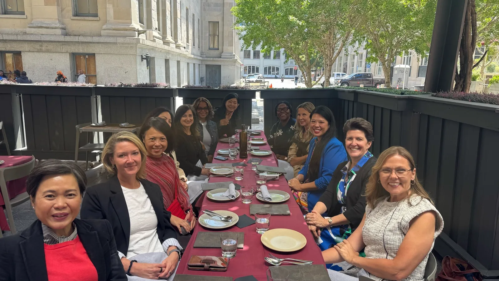 TBD community members sharing lunch at a long outdoor table in Atlanta