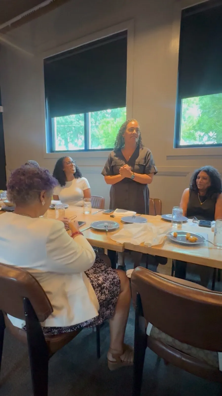 A TBD community member speaking to a small gathering during lunch